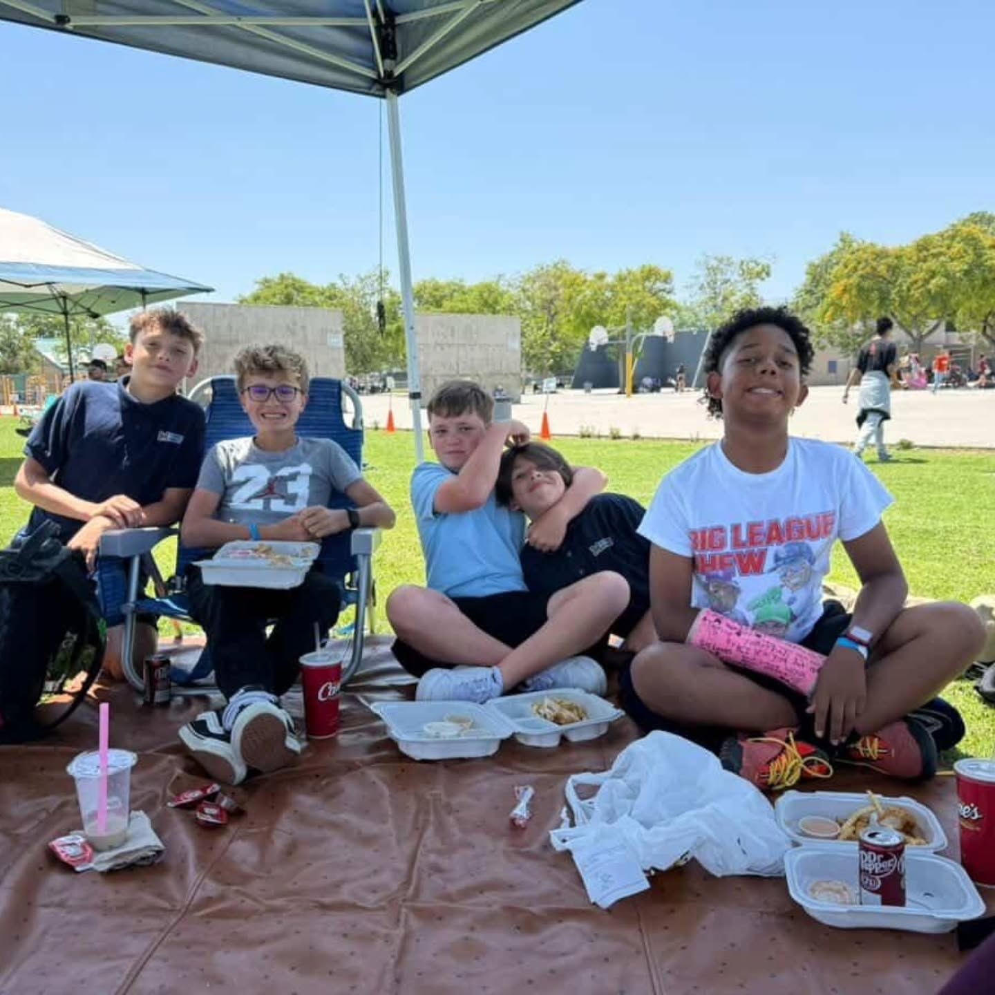 A group of McPherson students sharing lunch together on the school lawn