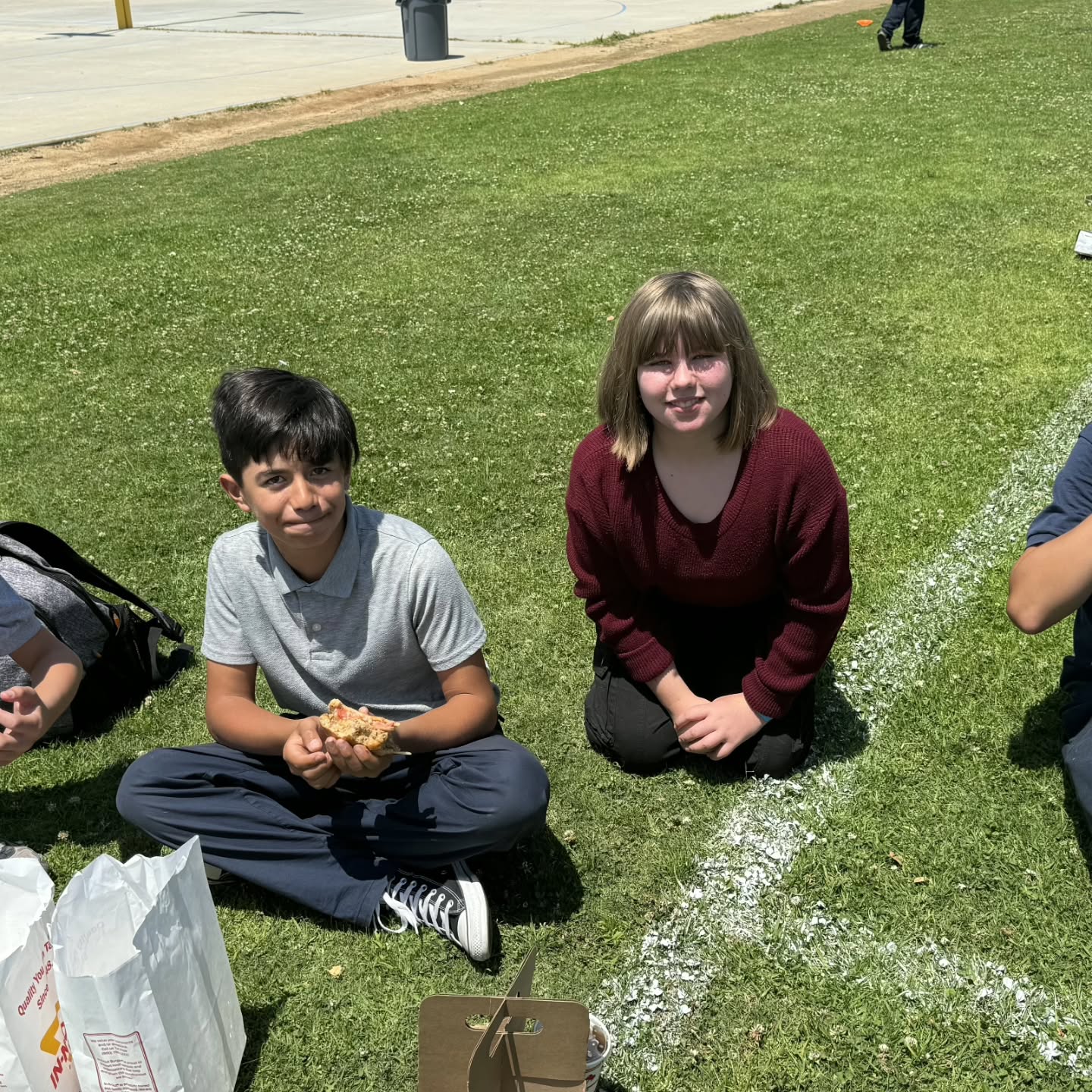 McPherson students sharing lunch together on the school lawn