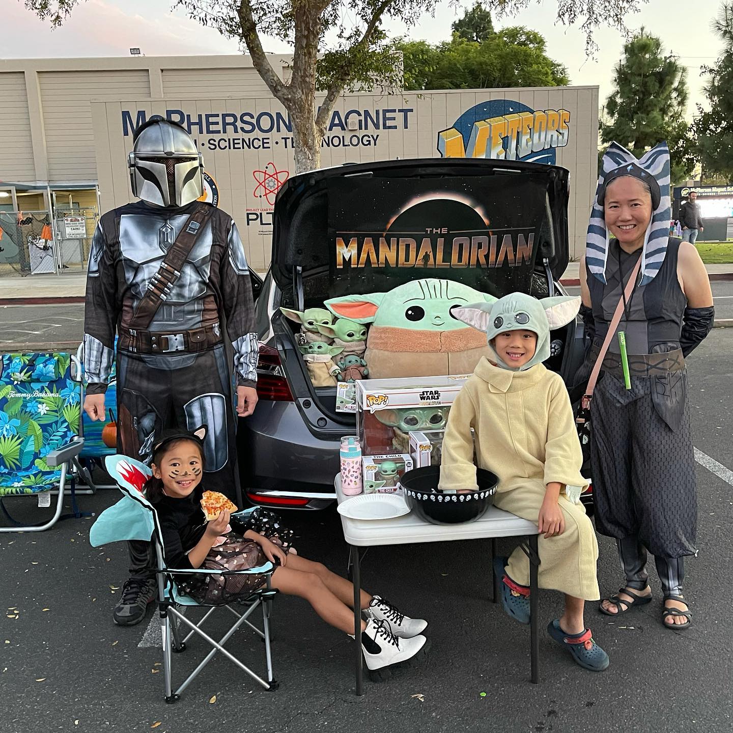 A McPherson family in Star Wars costumes beside their decorated trunk at the PTSA Trunk or Treat