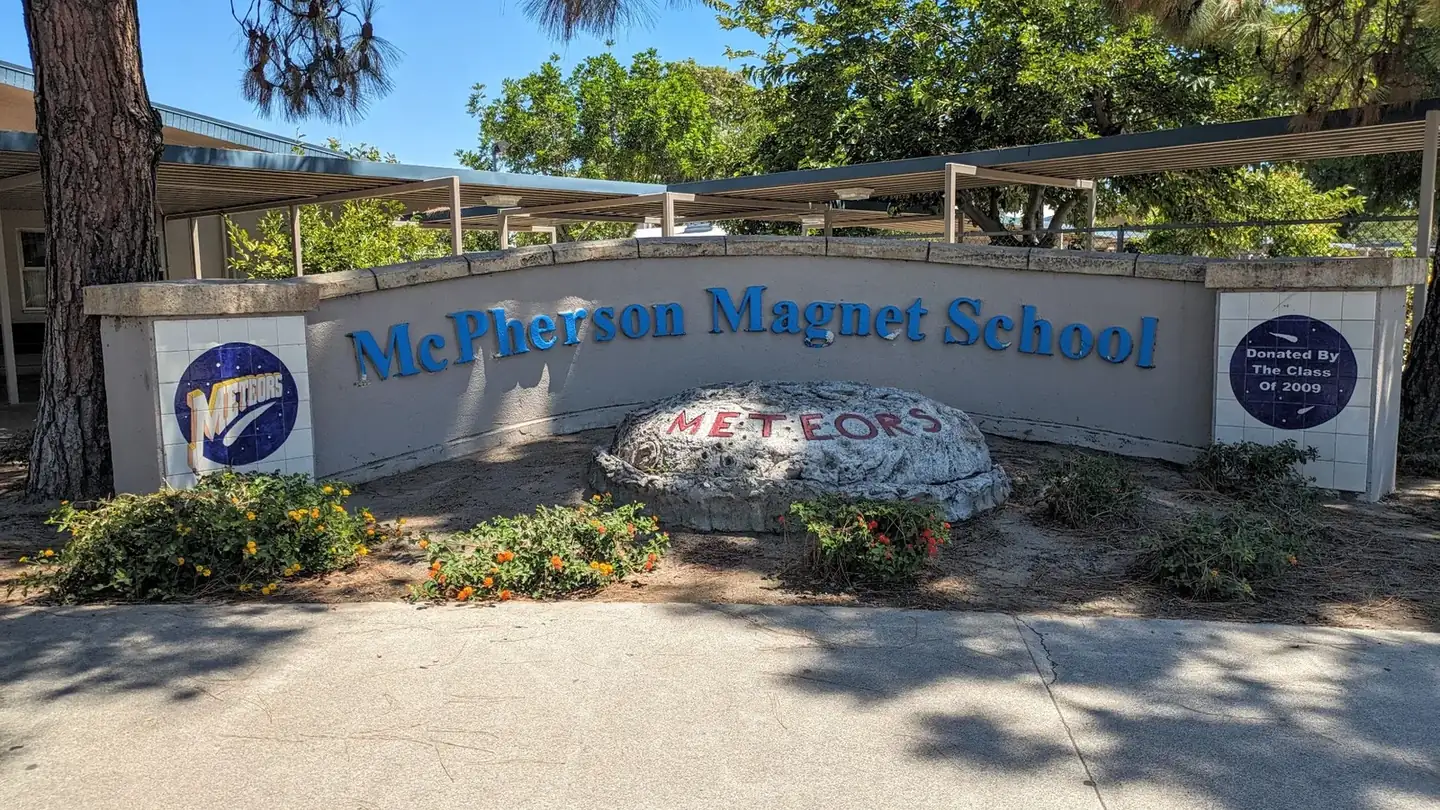 The McPherson Magnet School campus sign beneath mature trees