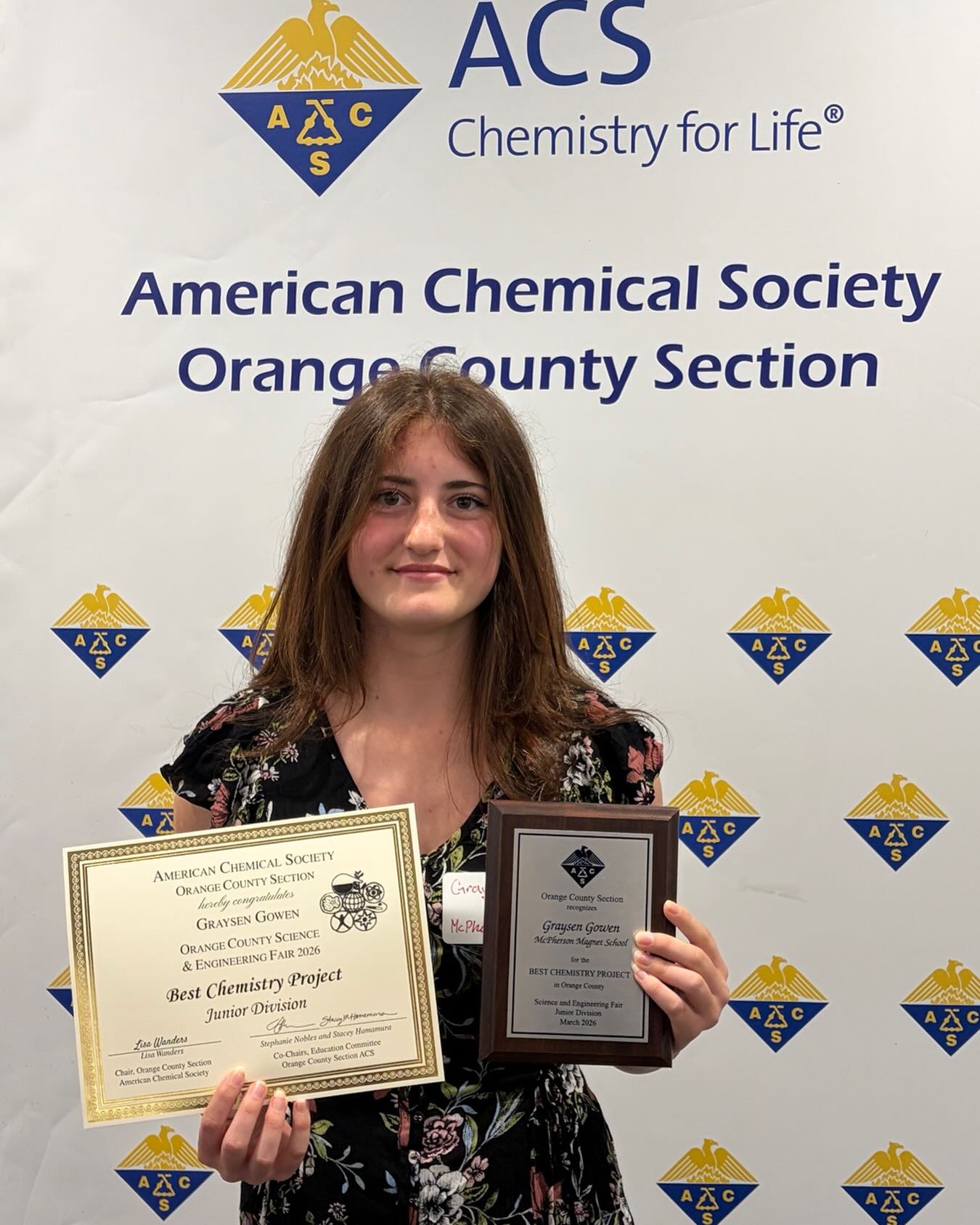 A McPherson student holding her American Chemical Society award for Best Chemistry Project